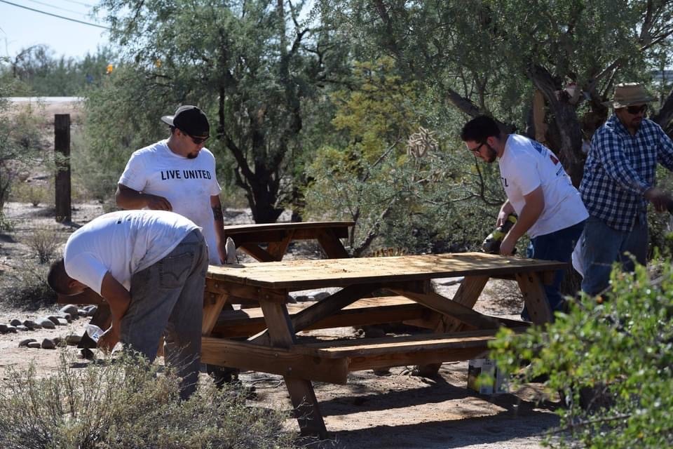 Volunteers working on picnic bench